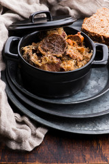 Traditional polish sauerkraut (bigos) with mushrooms and plums for christmas