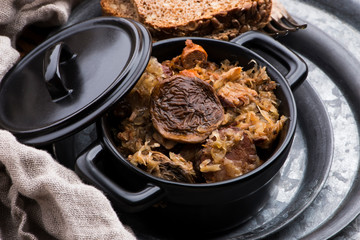 Traditional polish sauerkraut (bigos) with mushrooms and plums for christmas