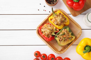 Flat lay composition with tasty stuffed bell peppers on white wooden table, top view