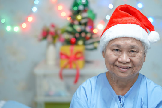 Asian Senior Or Elderly Old Lady Woman Patient With Santa Claus Helper Hat Very Happy In Christmas And New Year Celebration Festival Holiday Party In Hospital. .