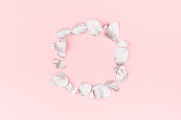 Obraz premium Valentine day background - blank wreath of silver eucalyptus leaves on pastel pink backdrop, top view, copy space.