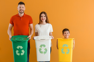 Family with containers for garbage on color background. Concept of recycling