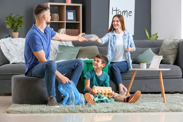 Family with garbage at home. Concept of recycling