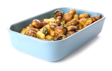 Baking dish with tasty cooked mushrooms and potato on white background