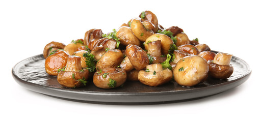 Plate with tasty cooked mushrooms on white background