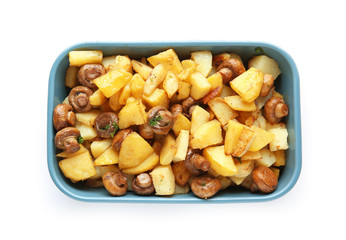 Baking dish with tasty cooked mushrooms and potato on white background