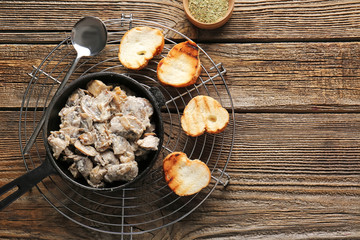 Fototapeta na wymiar Frying pan with tasty cooked mushrooms on table