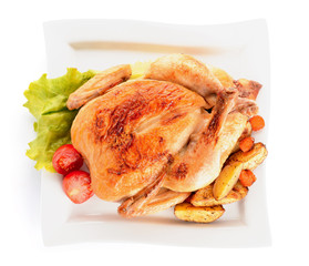 Plate with baked chicken and potato on white background