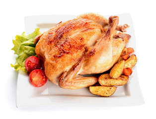 Plate with baked chicken and potato on white background