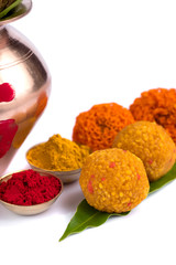 Copper Kalash with coconut, mango leaf, Haldi, kumkum and sweets with marigold flower decoration on...
