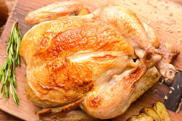 Baked chicken on wooden board