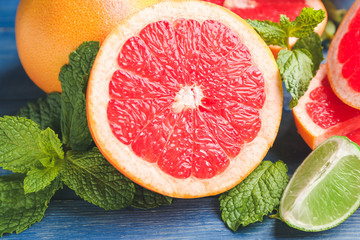 Fresh grapefruits and lime on table, closeup