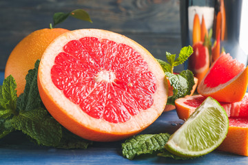 Fresh grapefruits and lime on table