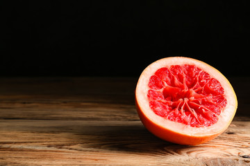 Fresh squeezed grapefruit on table against dark background