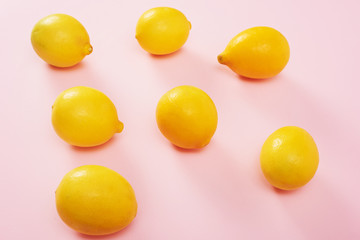 Lemons isolated on pink background. High Angle View Of Lemons. Free space for text.