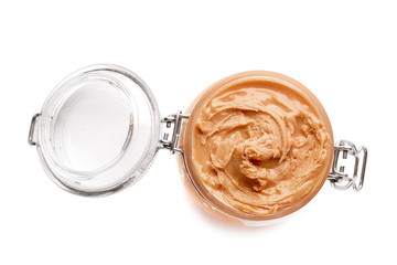 Tasty peanut butter in jar on white background