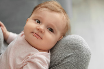 Young woman with her cute baby at home, closeup