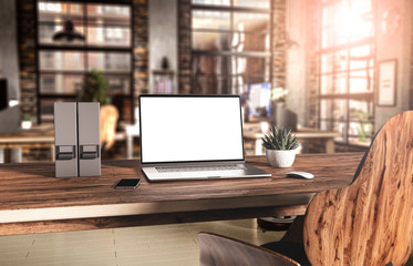 Laptop with blank screen mockup template on table in industrial old factory loft interior