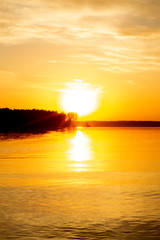 Blurred background. Beautiful golden sunset over a lake 