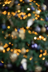 Fototapeta na wymiar Abstract New Year background with beautiful boke. Christmas tree lights. Illumination