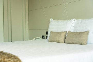 White comfortable pillow on bed decoration interior