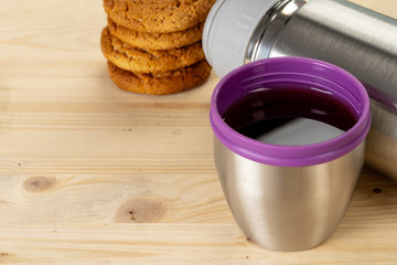 Aluminum metal thermos container bottle close up on table