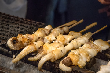 Vendor prepares seafood for sell in the Nishiki Market
