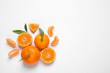 Composition with fresh ripe tangerines and leaves on white background, flat lay. Citrus fruit