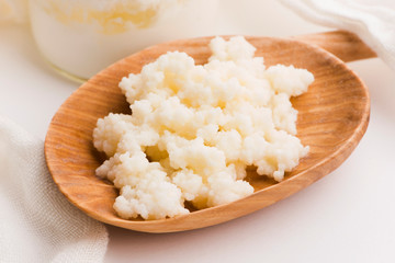 Milk kefir grains in spoon. Yeast bacterial fermentation starter