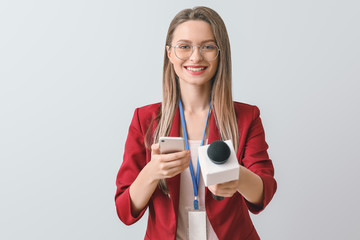 Female journalist on light background