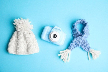 Flat lay composition with toy camera on light blue background. Future photographer
