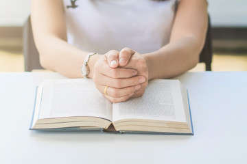 The Bible placed on the table was opened for learning to understand the Bible in order to pray to God and to ask God to protect himself and his family. The concept of Bible learning and faith in God
