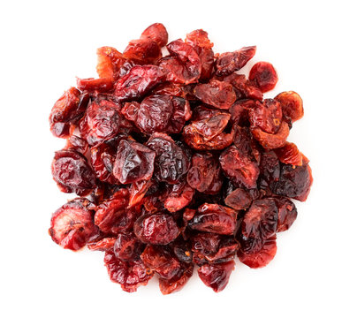 Pile of dried cranberries on a white. The view of the top.