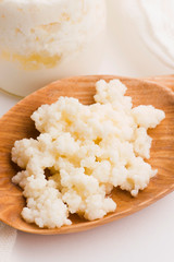Milk kefir grains in spoon. Yeast bacterial fermentation starter
