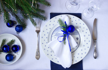 Christmas or New Year table decoration in white and blue colors.