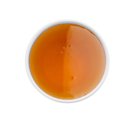 Bowl of organic honey isolated on white, top view