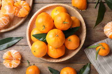Fresh ripe tangerines on wooden table, flat lay
