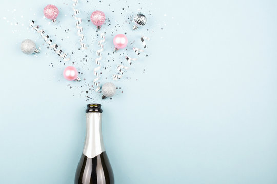 Christmas or New Year composition with champagne bottle and confetti.