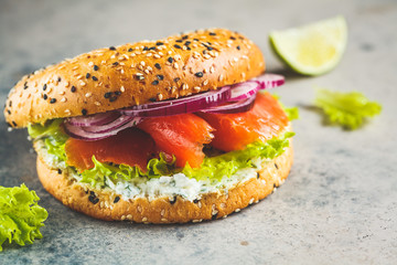Bagels with cream cheese, smoked fish, red onion and lettuce.