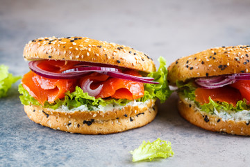 Bagels with cream cheese, smoked fish, red onion and lettuce.