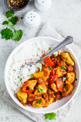 Jalfrezi chicken with rice in white bowl, top view, copy space. Traditional indian cuisine concept.
