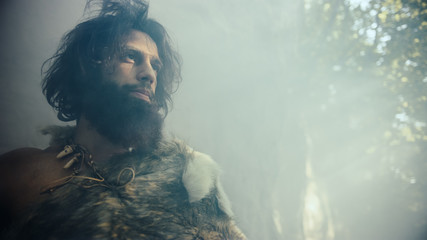 Primeval Caveman Wearing Animal Skin Holds Stone Hammer Looks Around Prehistoric Forest, Ready to...