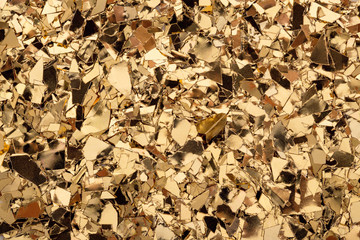 Gold glitter foil confetti background. Festive, party or holiday backdrop. Flat-lay, close-up.