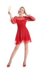 Happy young woman in Santa Claus hat and with glass of champagne on white background