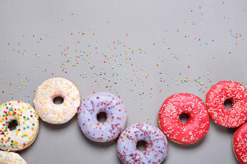 Sweet tasty donuts on grey background