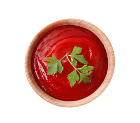 Tasty tomato sauce with parsley in wooden bowl isolated on white, top view