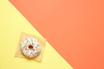 Sweet tasty donut on color background