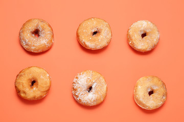 Sweet tasty donuts on color background