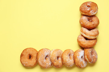 Sweet tasty donuts on color background