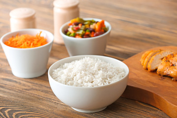 Bowl with tasty rice on table